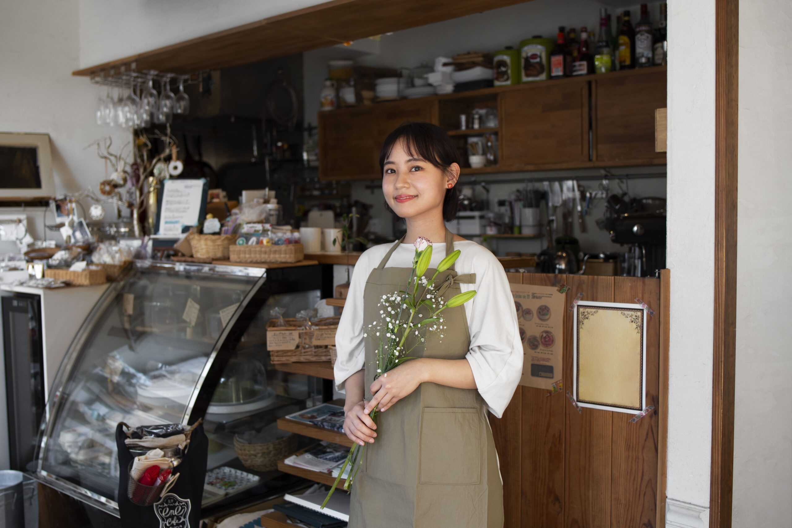 young woman arranging her cake shop