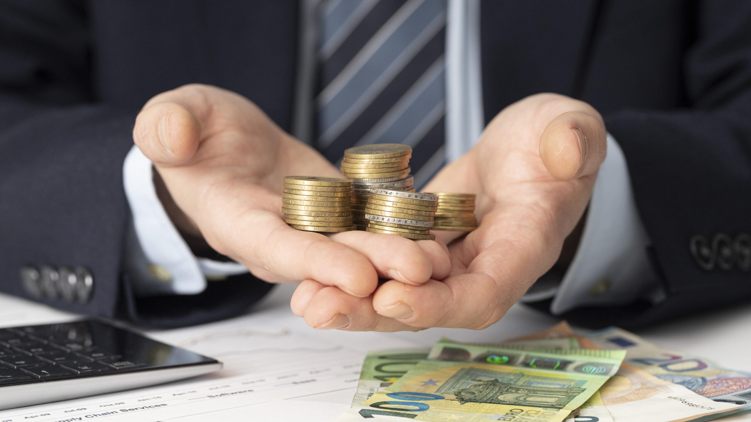 businessman holding bunch coins