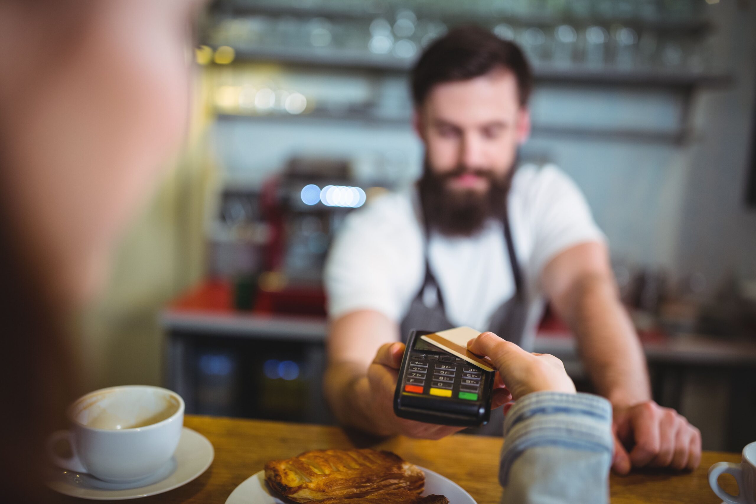 customer making payment through payment terminal counter